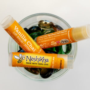 Three vanilla chai lip balm tubes in a bowl