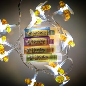 Bee lights surrounding lip balm tubes