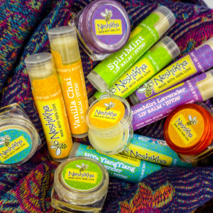 assorted lip balm tubes and pots on scarf