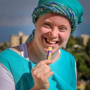 girl applying lip balm and smiling